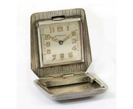 An Art Deco silver Eterna purse watch, casket shaped case with engine turned decoration and thumb piece, to square silvered d