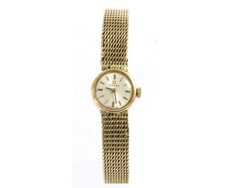 A ladies' 9ct gold Omega mechanical bracelet watch, c.1970, 18mm diameter with a silvered dial, baton hour markers and black 