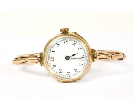 A ladies' 15ct gold mechanical bracelet watch, 22mm diameter with a white enamel dial, black Arabic numerals with red at the 