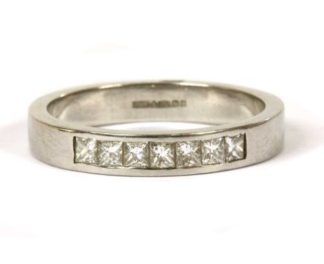 A platinum diamond half eternity ring, a row of seven princess cut diamonds with a stated total weight of 0.35ct, channel set