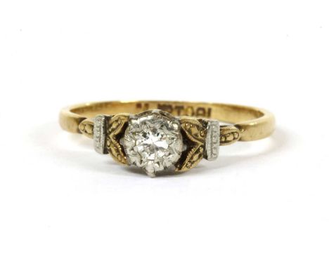 A gold single stone diamond ring, a Swiss cut diamond grain set to an illusion collet, to foliate shoulders and a D section s