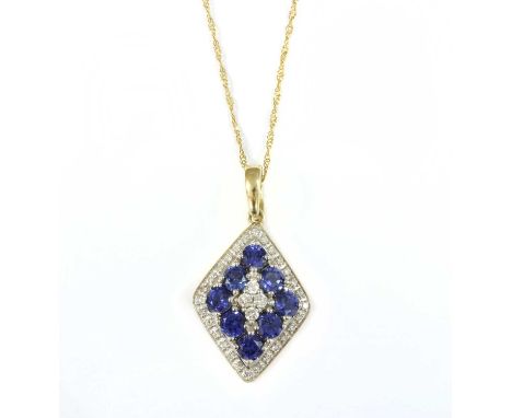 A 9ct gold diamond and tanzanite lozenge pendant, a quatrefoil of brilliant cut diamonds claw set to the centre, to surround 