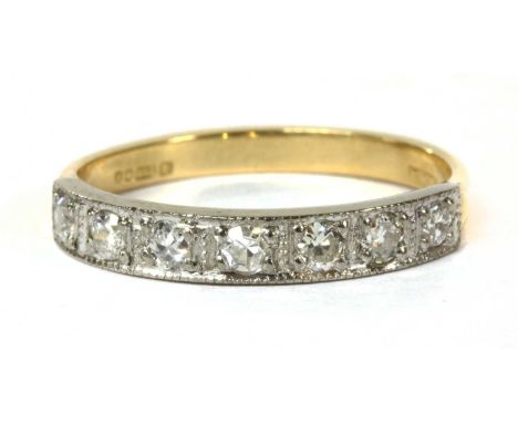 An 18ct gold diamond half eternity ring, Swiss and eight cut diamonds, grain set to the white gold head, to yellow gold split