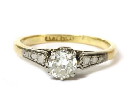 A gold single stone diamond ring, a transitional cut diamond claw set to a white rex collet, to spear shaped shoulders and a 