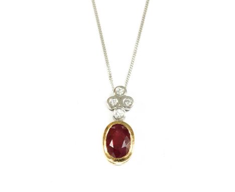 An 18ct gold ruby and diamond pendant, an oval mixed cut ruby with a stated weight of 1.25ct, rub set to a yellow gold collet