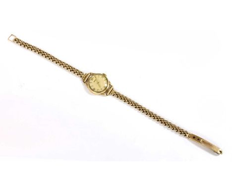 A ladies' 9ct gold Tissot mechanical bracelet watch, c.1950, circular case 20mm diameter, with a cream dial, raised gilt meta