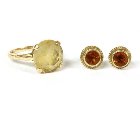 A 9ct gold single stone citrine ring, with a circular mixed cut citrine, double claw set to open shoulders and a plain shank,