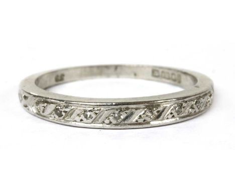 An 18ct white gold diamond half eternity ring, with a row of eight cut diamonds, grain set to the slightly tapered head, to f