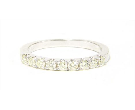 A 9ct white gold half eternity ring, with brilliant cut diamonds, micro claw set to a plain shank, Sheffield, 2.21g.Finger si