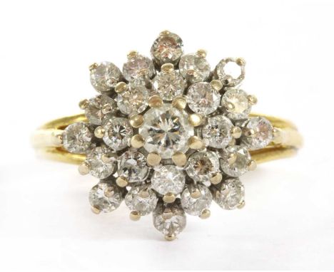 An 18ct gold diamond cluster ring, four tiers of brilliant cut diamonds, claw in set in white gold to a wire gallery, with ye