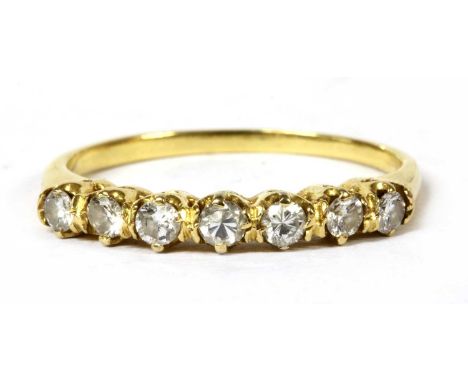 A gold diamond half eternity ring, a row of brilliant cut diamonds, claw set to rex collets, to solid shoulders and a plain s