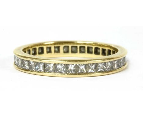 A gold princess cut diamond full eternity ring, a continuous row of princess cut diamonds, with an estimated total weight of 