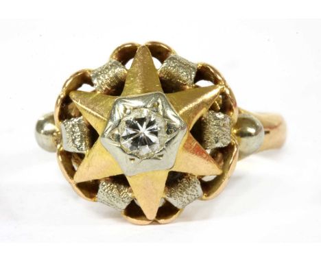 An Italian gold single stone diamond ring, c.1950, a brilliant cut diamond grain set to the centre, to star motif head with w