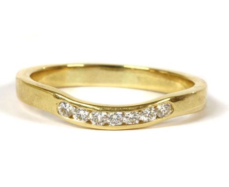 An 18ct gold shaped diamond half eternity ring, a row of brilliant cut diamonds with a stated total weight of 0.16ct, channel