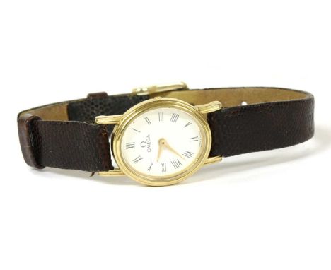 A ladies' 9ct gold Omega quartz strap watch, ref.1387, oval case 21 x 18mm, with a white enamel dial, black Roman numerals an