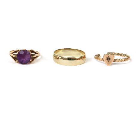 A gold single stone amethyst ring, circular mixed cut amethyst, claw set, to trifurcated shoulders and a plain shank, marked 