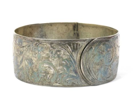 A sterling silver hinged bangle, by Charles Horner, with hand engraved decoration, Chester 1938, 41.04g, together with a smal