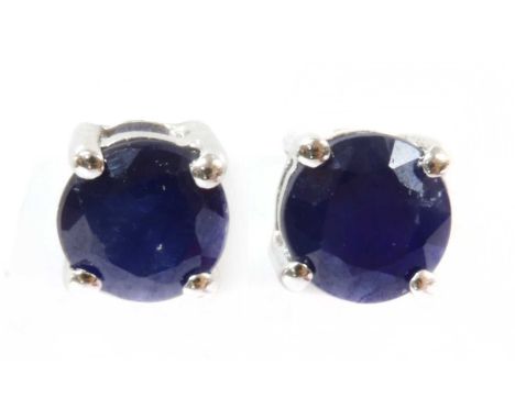 A pair of white gold sapphire stud earrings, a circular mixed cut sapphire, claw set, to post and scroll fittings, marked 9k,