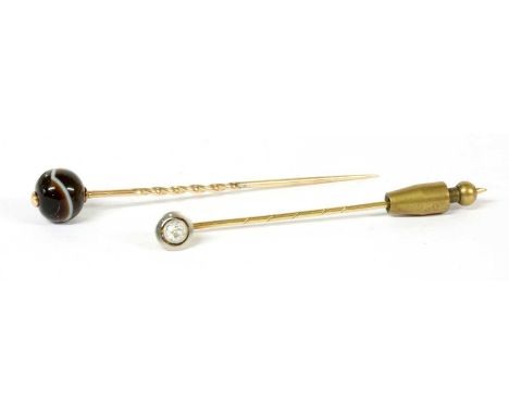 A gold diamond stick pin, an old brilliant cut diamond, milligrain set to a white gold frame, with yellow gold gallery and pi