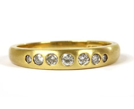 An 18ct gold seven stone diamond ring, with a row of graduated brilliant cut diamonds with a stated total weight of 0.24ct, g