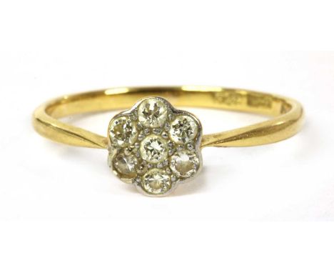 A gold diamond daisy cluster ring, a cluster of brilliant and eight cut diamonds grain set to a scalloped edge, to solid tape