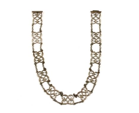 An Edwardian sterling silver belt, with scroll panels joined by lengths of trace chain, to buckle, London 1904, 605mm long, 9