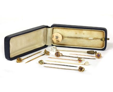 A collection of ten stick pins, to include one with gold disc finial star set with a rose cut diamond, tested as 18ct gold wi