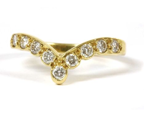 An 18ct gold diamond wishbone ring, with a row of nine brilliant cut diamonds with a stated total weight of 0.43ct, grain set