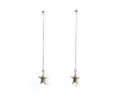 A pair of white gold diamond set star drop earrings, ten rayed star grain set with brilliant cut diamonds, to paper link chai