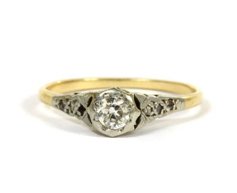 A gold single stone diamond ring, a brilliant cut diamond grain set to an illusion collet, to tapering shoulders grain set wi