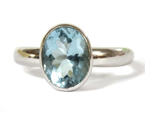 An 18ct white gold single stone aquamarine ring, an oval mixed cut aquamarine with a stated weight of 2.12ct, rub set to a da