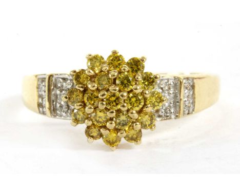 A 9ct gold diamond and treated yellow diamond ring, a cluster of brilliant cut treated yellow diamonds, claw set to the head,