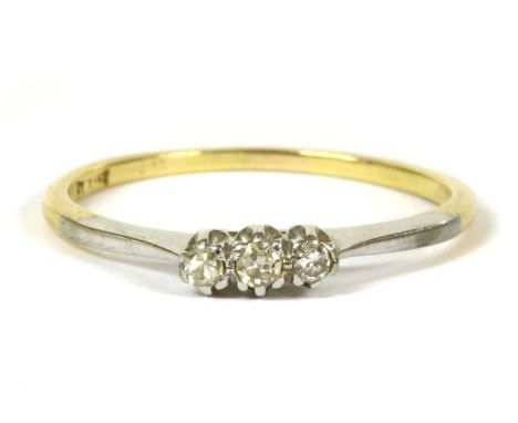 A two colour gold three stone diamond ring, three eight cut diamonds claw to white gold rex collets, with solid tapering whit