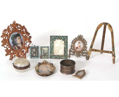 Mixed Lot:  A hand painted porcelain plaque mounted in an ornate carved treen leaf decorated easel backed frame, an easel bac