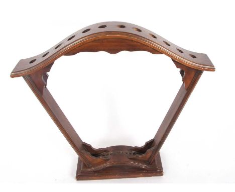 A stained wooden fan shaped stick stand for twelve sticks 2 feet 4 inches tall