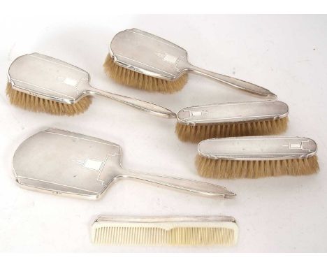 Art Deco silver backed dressing table items to include two hairbrushes, hand mirror, comb, two clothes brushes all with engin