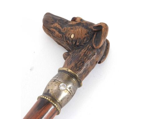 A vintage carved dog head walking stick, the head inset with glass eyes, articulated jaw opening his mouth by pressing spring