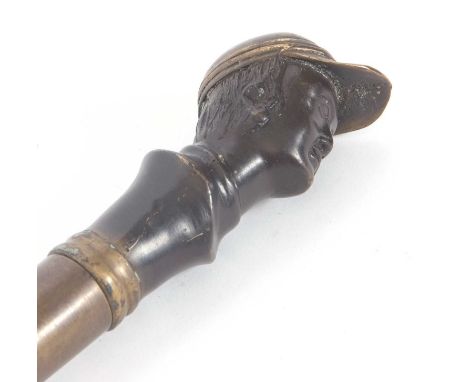 Vintage walking stick/cane with a weighted brass jockeys head on a later wooden shaft (a/f)