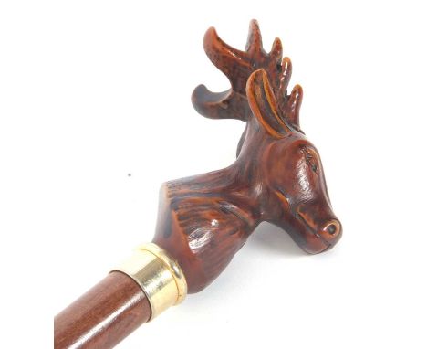 A carved stags head walking stick, gilt metal ferrule and cane shaft