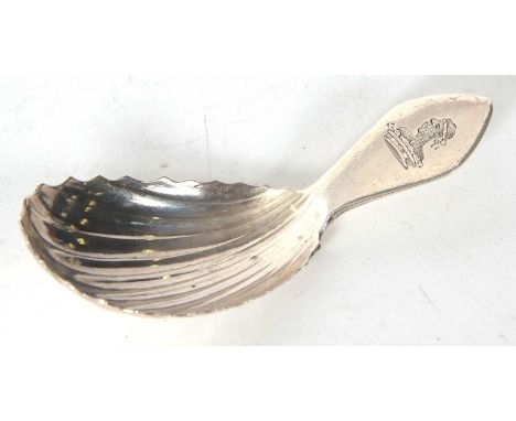 A George III Irish silver caddy spoon, oval shaped shell bowl and engraved with a figural crest, hallmarked for Dublin 1813, 