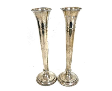 Pair of Elizabeth II silver tall spill vases having beaded decoration to rims and bases, engraved ring turned necks to a spre