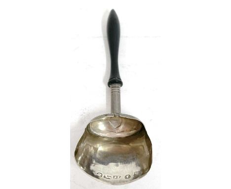 A George III silver caddy spoon with shovel shaped bowl and turned ebonised handle, hallmarked for Birmingham 1816, makers ma