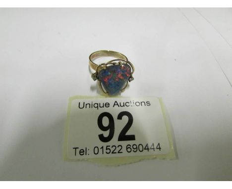 An Australian black opal ring set with diamond to each shoulder in contemporary 9ct gold setting, size M