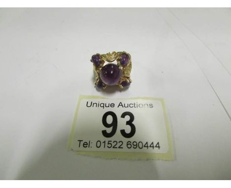 An amethyst cabachon cut dated London 1973 in textured 9ct gold, 11.14gms in total, size O