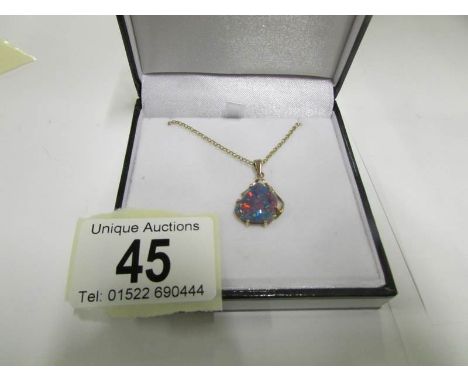 An Australian black opal pendant with 9ct gold setting and on gold chain