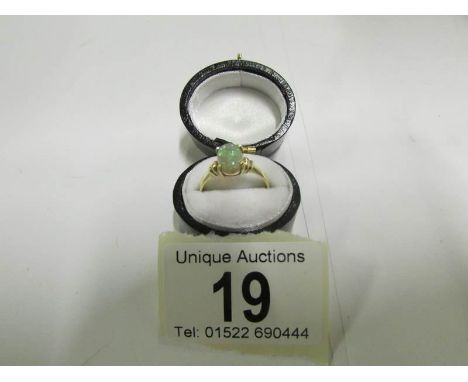 An Australian natural opal ring set in 9ct gold, size L