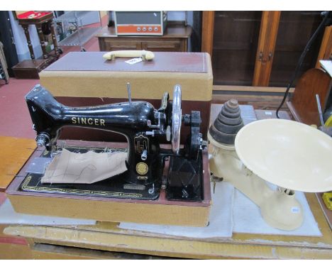 A Xx Century singer Sewing Machine, (cased), together with cream painted kitchen scales and weights (2).
