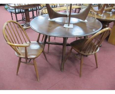 A Ercol Drop Leaf Dining Table, on splayed legs with X stretcher, two carver and two single chairs (5).