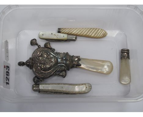 A Silver Baby Rattle, having four drop bells and mother of pearl handle, two silver bladed mother of pearl fruit knives, etc.