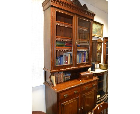 A late 19th century mahogany bureau bookcase , the projecting base with two drawers over two panelled doors, bracket feet, c.